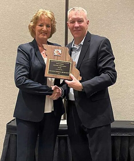 CHERYL BURNETT receiving the Gary Filbert Award