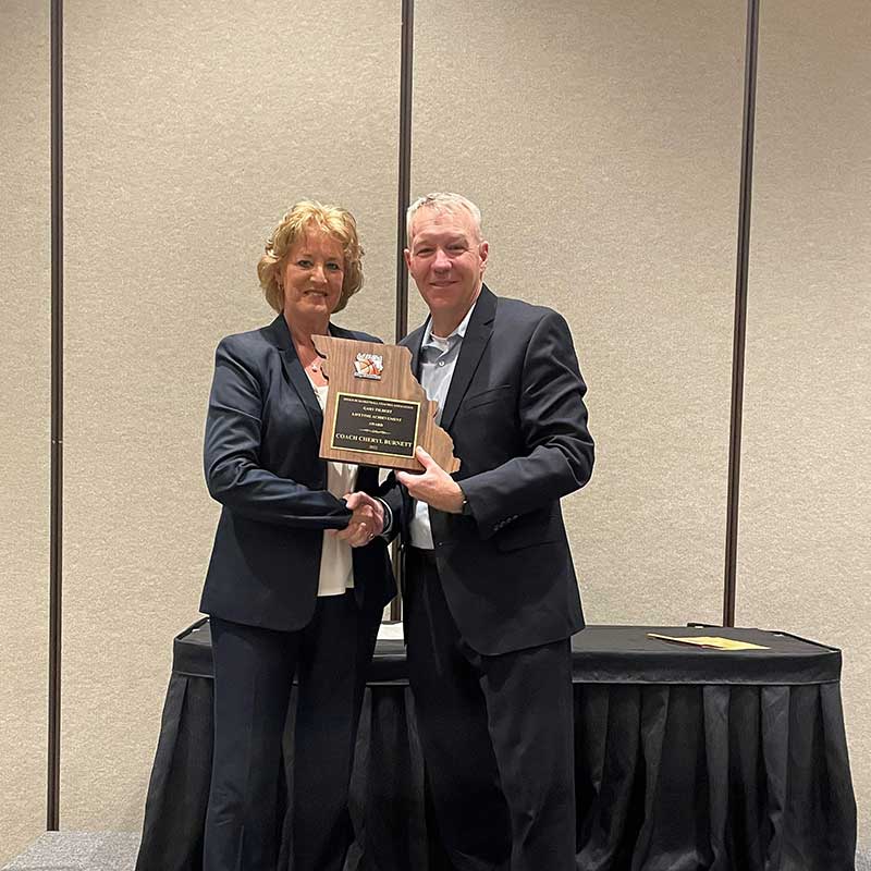 CHERYL BURNETT receiving the Gary Filbert Award